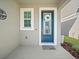 Charming front entrance with blue door, seasonal wreath, and gray siding at 6520 Great Bear Dr, Lakeland, FL 33805