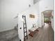 Hallway with stairs, bench seating, decorative ladder, and access to other rooms at 6520 Great Bear Dr, Lakeland, FL 33805