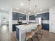 Modern kitchen features custom blue cabinets, quartz countertops, an island, and stainless appliances at 6520 Great Bear Dr, Lakeland, FL 33805