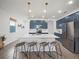 Charming kitchen featuring a large island with barstool seating and unique globe pendant lighting at 6520 Great Bear Dr, Lakeland, FL 33805