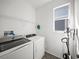 Efficient laundry room features a washer, dryer, and shelving for convenient storage and organization at 6520 Great Bear Dr, Lakeland, FL 33805