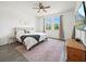 Inviting main bedroom with neutral tones, bright windows, and a ceiling fan for a comfortable atmosphere at 6520 Great Bear Dr, Lakeland, FL 33805