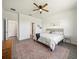 Bright main bedroom features a ceiling fan and a cozy rug, creating a relaxing and inviting atmosphere at 6520 Great Bear Dr, Lakeland, FL 33805
