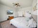 Serene main bedroom with a ceiling fan, TV, and an ensuite bathroom, perfect for relaxation and privacy at 6520 Great Bear Dr, Lakeland, FL 33805