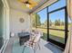 Relaxing screened lanai showcases comfortable seating and views of the backyard and nearby lake at 6520 Great Bear Dr, Lakeland, FL 33805