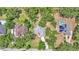 Aerial view of the property highlights its location amidst lush greenery, showcasing neighborhood layout and proximity to amenities at 6735 Forestwood W Dr, Lakeland, FL 33811