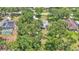 Aerial view of property with mature trees, a pool, and a well-manicured lawn at 6735 Forestwood W Dr, Lakeland, FL 33811