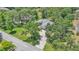 An aerial view of a well-maintained single-story home surrounded by mature trees and a long driveway at 6735 Forestwood W Dr, Lakeland, FL 33811