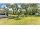 Spacious backyard with mature trees, a shed, and plenty of open space for outdoor activities and relaxation at 6735 Forestwood W Dr, Lakeland, FL 33811