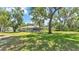 Expansive backyard featuring mature trees, offering a serene and private outdoor space at 6735 Forestwood W Dr, Lakeland, FL 33811