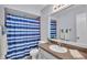 Bathroom featuring a vanity with a granite countertop and a shower with a blue curtain at 6735 Forestwood W Dr, Lakeland, FL 33811