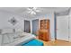 Bright bedroom features a sloped ceiling, wood floors and a ceiling fan at 6735 Forestwood W Dr, Lakeland, FL 33811
