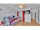 Bedroom featuring wood floors, a ceiling fan, and a closet with a red curtain at 6735 Forestwood W Dr, Lakeland, FL 33811