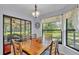 Bright dining room with a view of the screened lanai and backyard, creating an inviting space at 6735 Forestwood W Dr, Lakeland, FL 33811