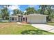 Charming single-story home featuring a well-manicured lawn and an attached two-car garage at 6735 Forestwood W Dr, Lakeland, FL 33811