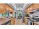 Well-lit kitchen features stainless appliances, tile floors, and a breakfast bar overlooking the dining area at 6735 Forestwood W Dr, Lakeland, FL 33811