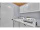 The Laundry Room showcases Maytag washer and dryer set, complemented by white cabinets and wooden ceiling detail at 6735 Forestwood W Dr, Lakeland, FL 33811