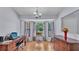Bright living area featuring a bay window with views of the landscaped yard and an elegant chandelier at 6735 Forestwood W Dr, Lakeland, FL 33811