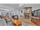 Cozy living room featuring a stone fireplace, plush seating, and hardwood floors, perfect for relaxing at 6735 Forestwood W Dr, Lakeland, FL 33811