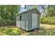 This backyard features a storage shed, offering extra space and organization for tools and outdoor equipment at 6735 Forestwood W Dr, Lakeland, FL 33811
