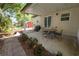 Cozy covered patio and backyard with a grill, shed, patio and landscaped garden area at 705 W Park St, Lakeland, FL 33803