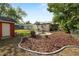 Expansive backyard with garden, shed, and fire pit, perfect for outdoor activities and relaxation at 705 W Park St, Lakeland, FL 33803