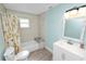Bathroom featuring shower over tub with updated tile, stylish vanity with modern mirror and lighting at 705 W Park St, Lakeland, FL 33803