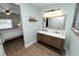 The bathroom features a double sink vanity with a mirror, and an adjacent bedroom at 705 W Park St, Lakeland, FL 33803