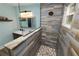 Stylish bathroom featuring a single sink vanity and a beautifully tiled shower area at 705 W Park St, Lakeland, FL 33803
