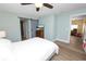 Well-lit bedroom featuring wood floors, a ceiling fan, stylish furnishings, and a gray sliding barn door at 705 W Park St, Lakeland, FL 33803