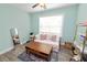 This bedroom features modern, light green walls, wood-look flooring, daybed, and a decorative rug at 705 W Park St, Lakeland, FL 33803