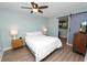 Inviting bedroom with wood floors, a ceiling fan, stylish furnishings, and a gray sliding barn door at 705 W Park St, Lakeland, FL 33803