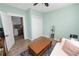 Bedroom featuring light green walls, wood-look flooring, closet, and a door leading to the kitchen at 705 W Park St, Lakeland, FL 33803