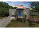 Inviting one-story home with a brick driveway, xeriscape landscaping, and a vibrant blue front door at 705 W Park St, Lakeland, FL 33803