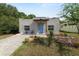 Charming home featuring a blue front door, well-maintained landscaping, and a paved walkway and driveway at 705 W Park St, Lakeland, FL 33803