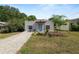 Attractive single-story home featuring a bright blue door, a brick driveway and minimal, xeriscape landscaping at 705 W Park St, Lakeland, FL 33803