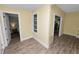 Bright hallway featuring new floors, paint and trim and featuring views of other rooms in the home at 705 W Park St, Lakeland, FL 33803