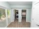 Bright laundry room featuring a stacked washer and dryer, light hardwood floors and plenty of natural light at 705 W Park St, Lakeland, FL 33803