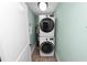 A well-lit laundry area with a stacked washer and dryer, and a water heater at 705 W Park St, Lakeland, FL 33803