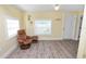 Bright and cozy living room featuring natural light, a comfortable chair, and access to the front entry at 705 W Park St, Lakeland, FL 33803