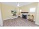 Bright living room featuring a decorative fireplace, neutral walls, modern ceiling fan, and wood-look flooring at 705 W Park St, Lakeland, FL 33803