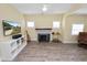 This living room features a ceiling fan, entertainment center, and a decorative fireplace at 705 W Park St, Lakeland, FL 33803