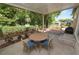 Enjoy this cozy covered outdoor patio area, complete with a table and seating, perfect for relaxing outdoors at 705 W Park St, Lakeland, FL 33803