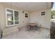 Covered patio with table and chairs, offering an inviting outdoor living space connected to the home at 705 W Park St, Lakeland, FL 33803