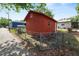 View of backyard shed featuring access gate, a small window, and functional yard storage at 705 W Park St, Lakeland, FL 33803