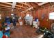 A cluttered storage shed with exposed studs and rafters that is suitable for storage of yard equipment at 705 W Park St, Lakeland, FL 33803