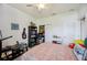 A bedroom featuring a ceiling fan, a closet, a door, and a bed with patterned bedspread at 7088 Remington Oaks Loop, Lakeland, FL 33810