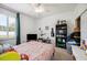 A bedroom featuring a ceiling fan, window with shutters, and a decorative guitar hanging on the wall at 7088 Remington Oaks Loop, Lakeland, FL 33810