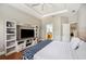 Comfortable bedroom with an ensuite bathroom and built-in media center at 7088 Remington Oaks Loop, Lakeland, FL 33810