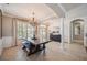 Charming dining area with a rustic table, decorative lighting, and elegant architectural details at 7088 Remington Oaks Loop, Lakeland, FL 33810